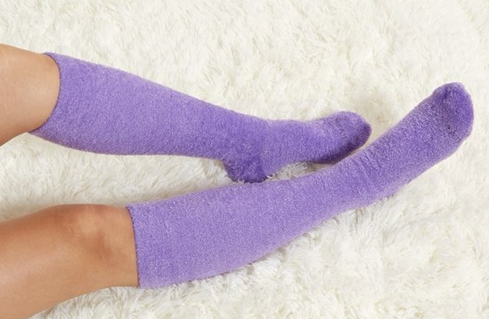 model wearing the purple fuzzy socks