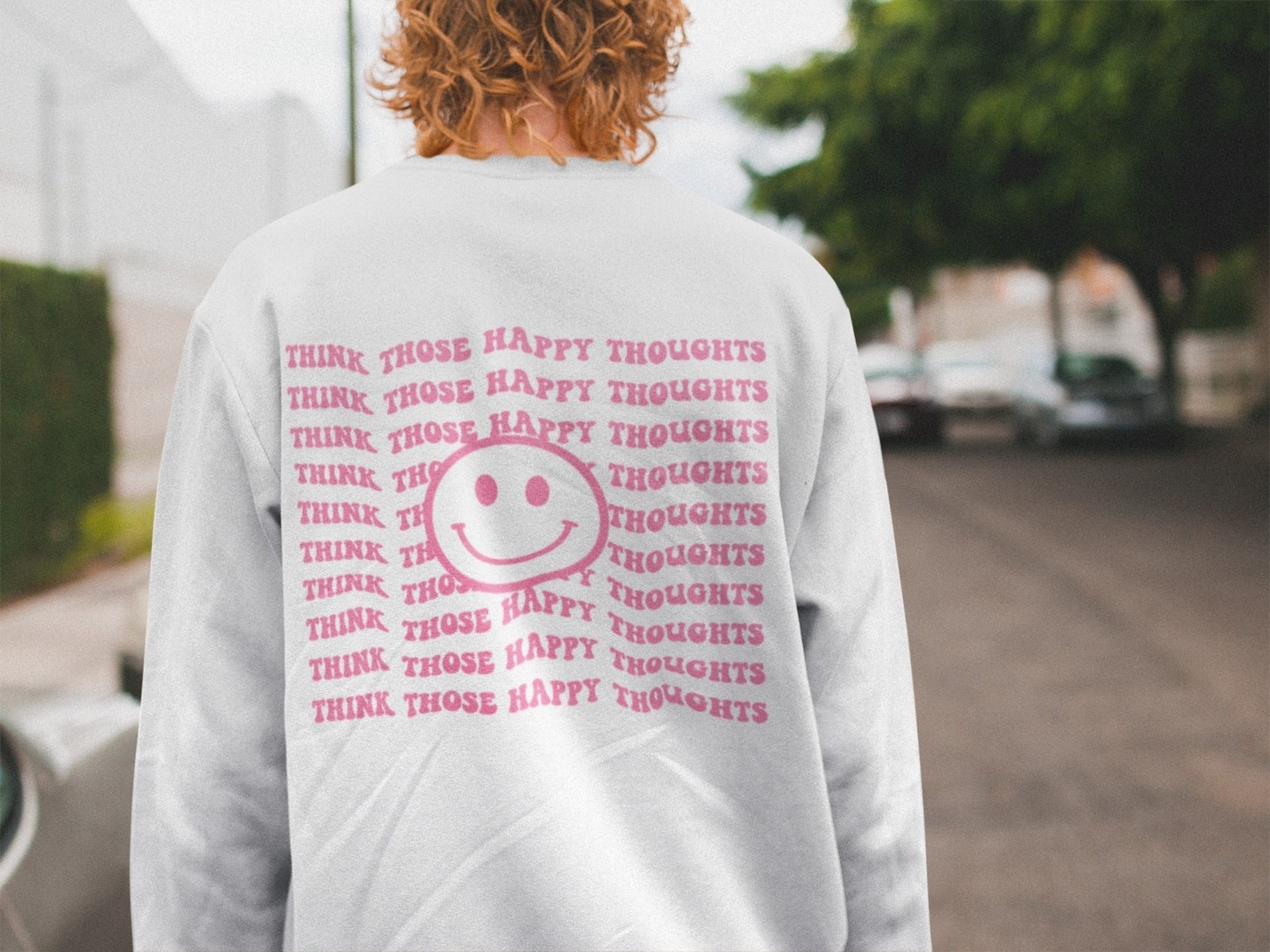 sweatshirt with a smiley face and &quot;think those happy thoughts&quot; design on the back