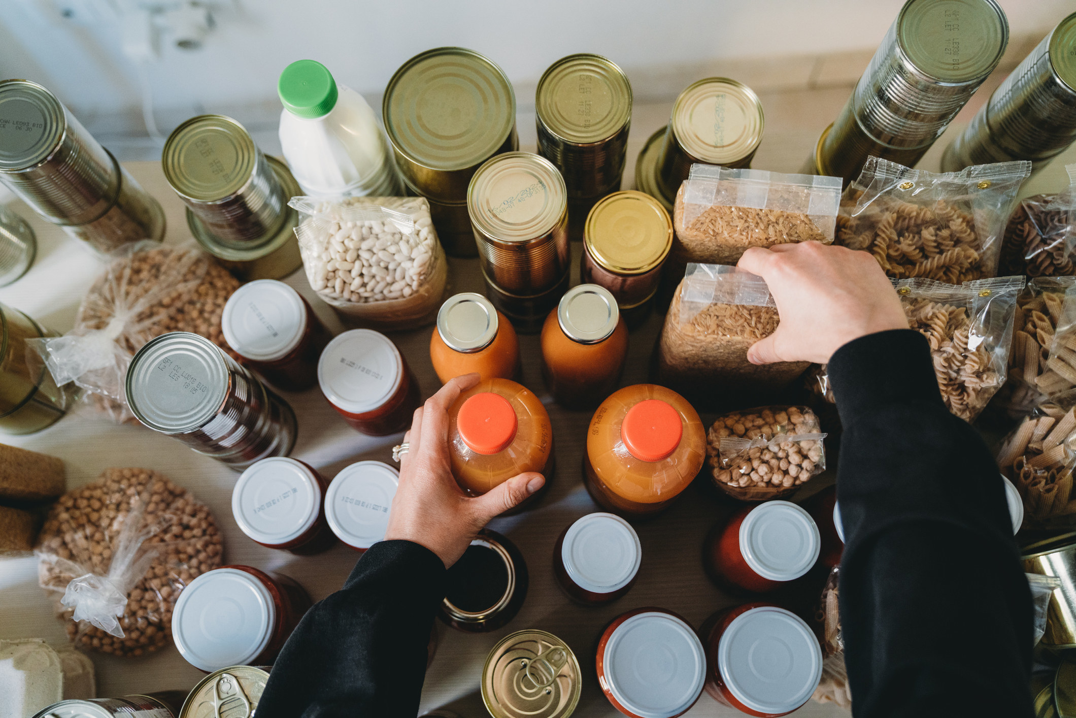 A person organizing dry and canned goods