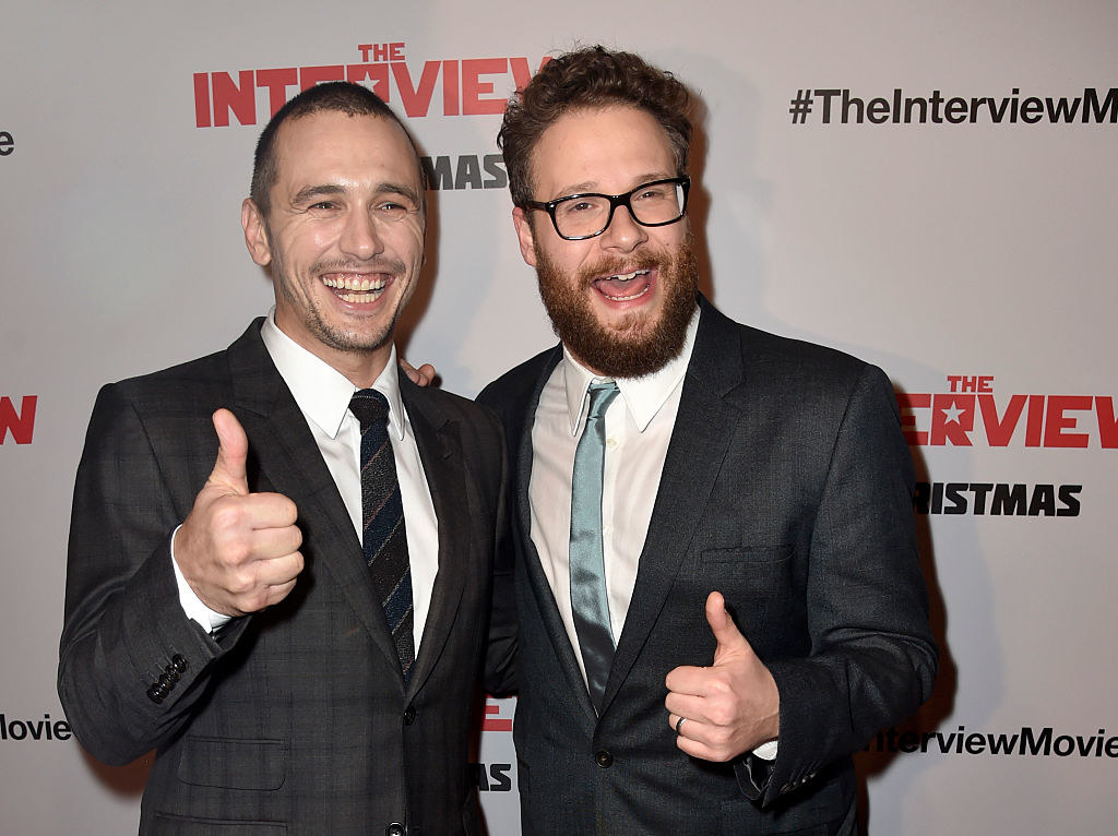 James and James, both wearing suits, giving a thumbs up to the cameras at a red carpet event