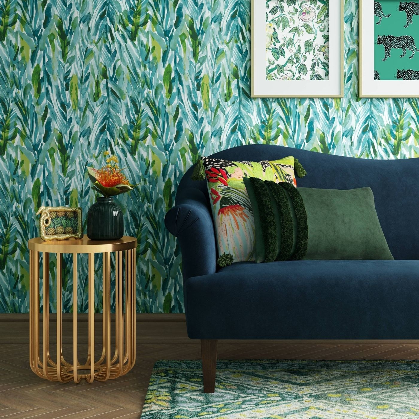 A gold side table next to a navy blue couch with a matching leaf rug and wallpaper background.