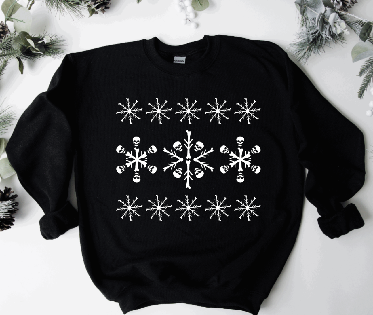 sweatshirt with snowflake pattern on it that&#x27;s made up of skulls and bones once you look closely at it