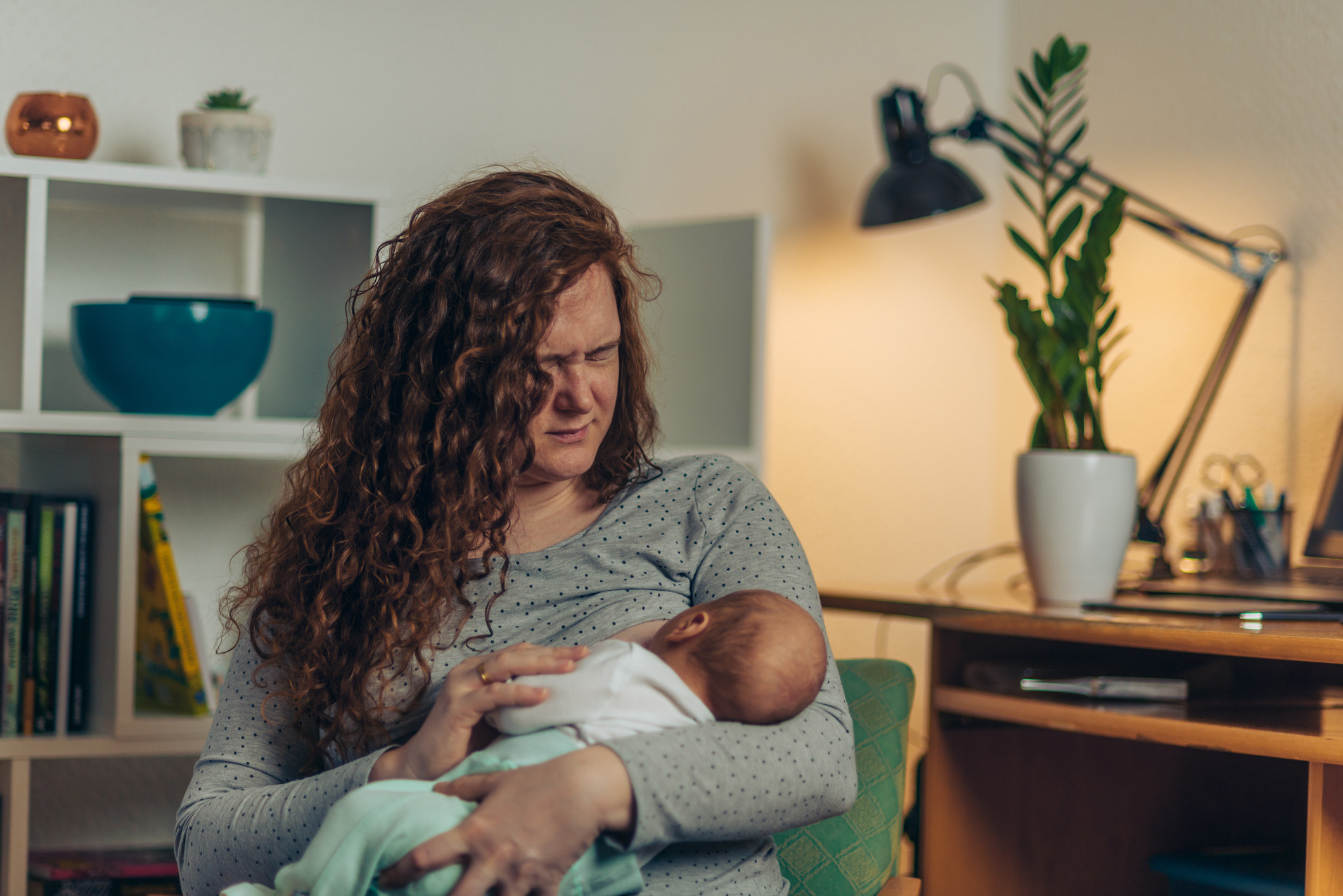 A woman breastfeeding in pain