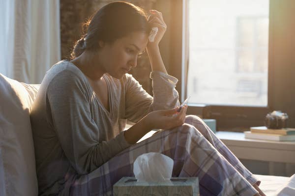 A nervous woman looking at a pregnancy test