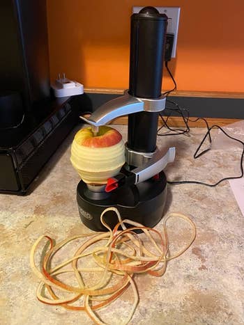 the peeler peeling an apple