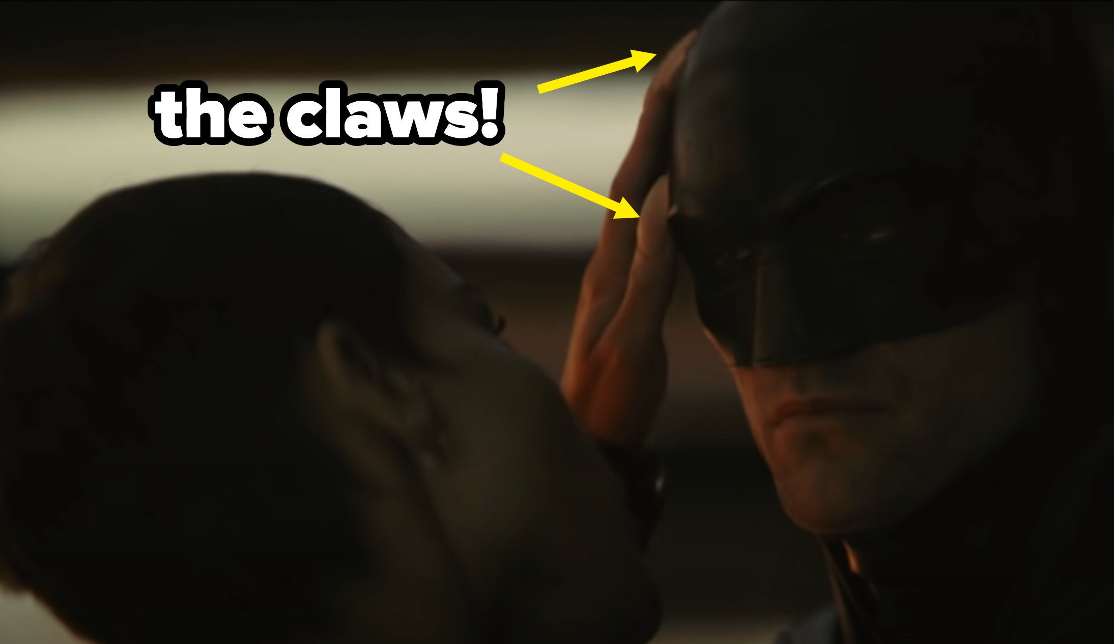 Catwoman caressing Batman&#x27;s face