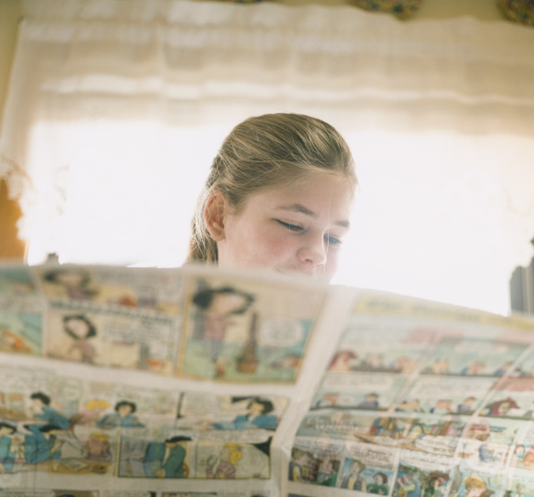 Little girl reading comics page