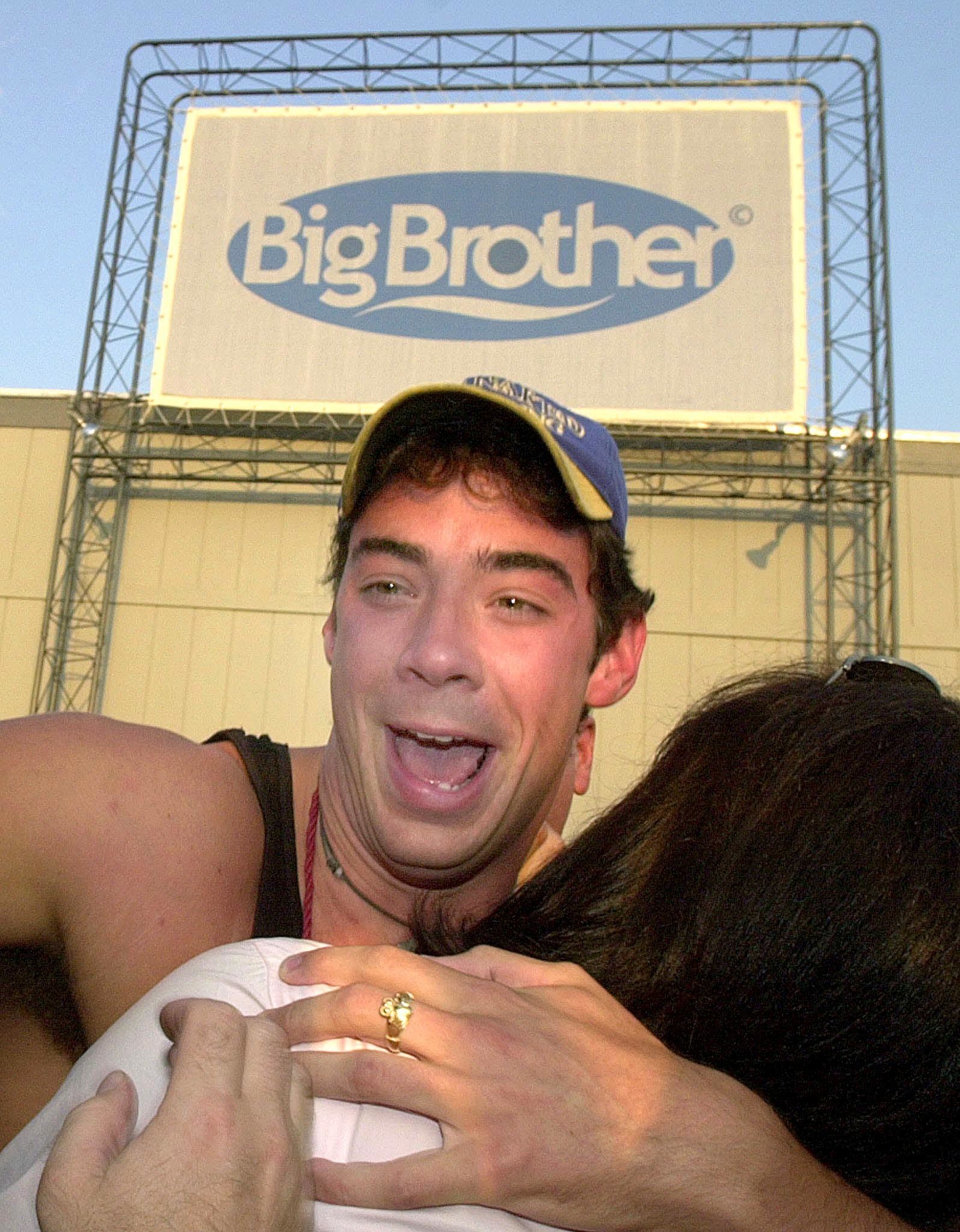 Eddie McGee laughing and hugging someone