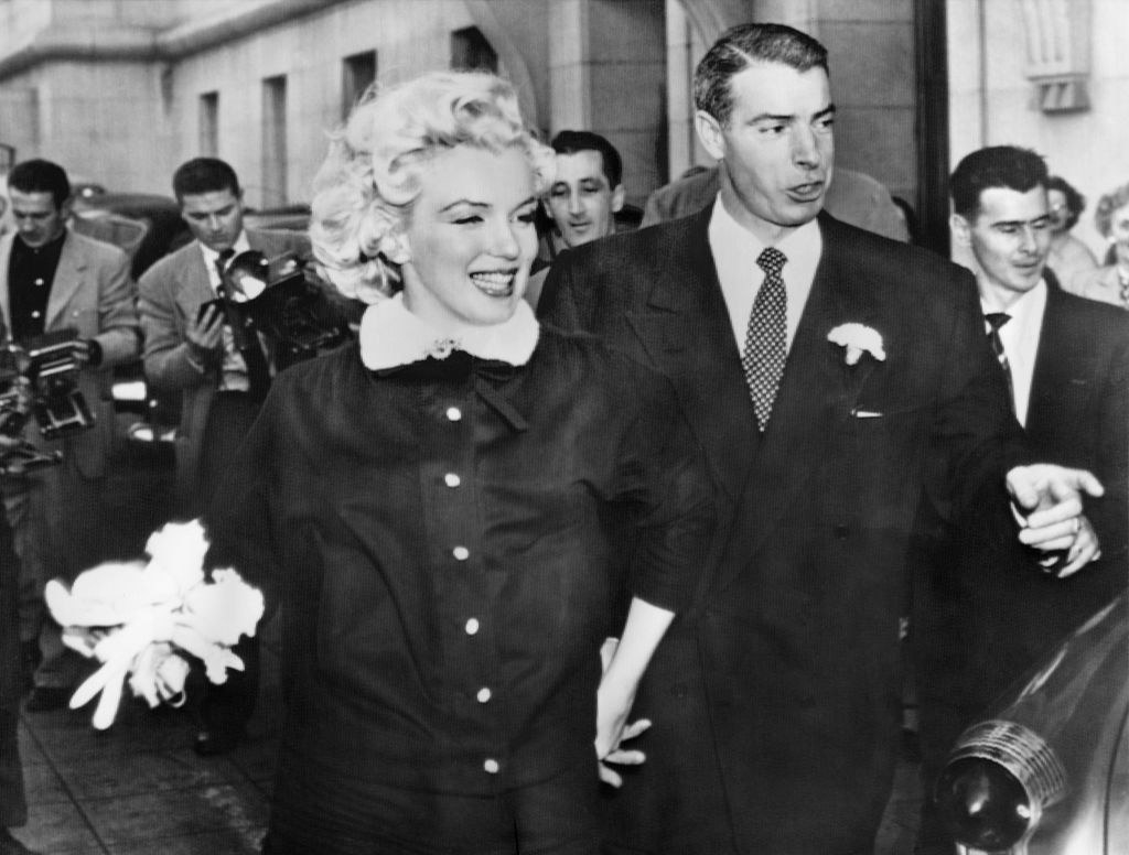 Marilyn and Joe holding hands after getting married