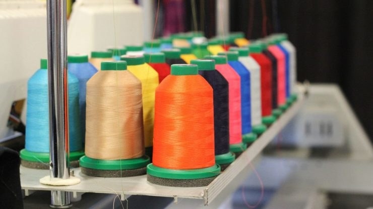 A bunch of spools of different colored thread