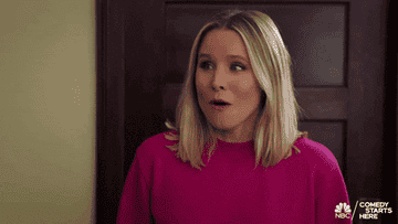 a gif of kristen bell in the good place saying holy forking shirt balls