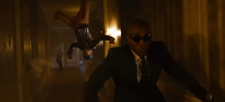 Morpheus running down a hall with Bugs in midair and upside down in &quot;The Matrix Resurrections&quot;