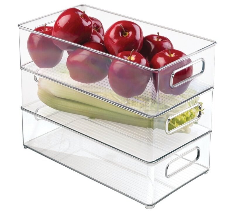 the three clear bins with apples and celery