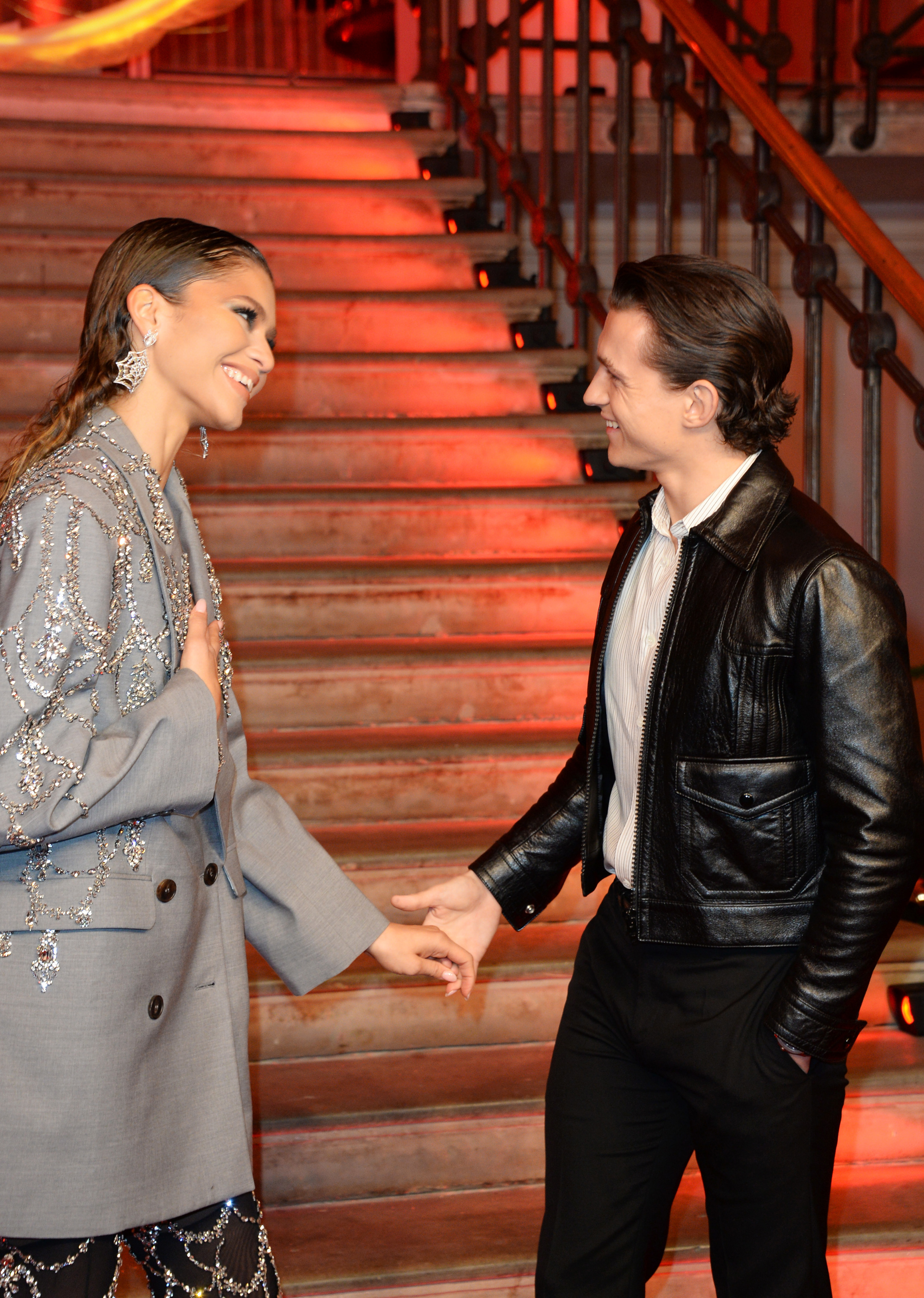 Zendaya and Tom holding hands and laughing