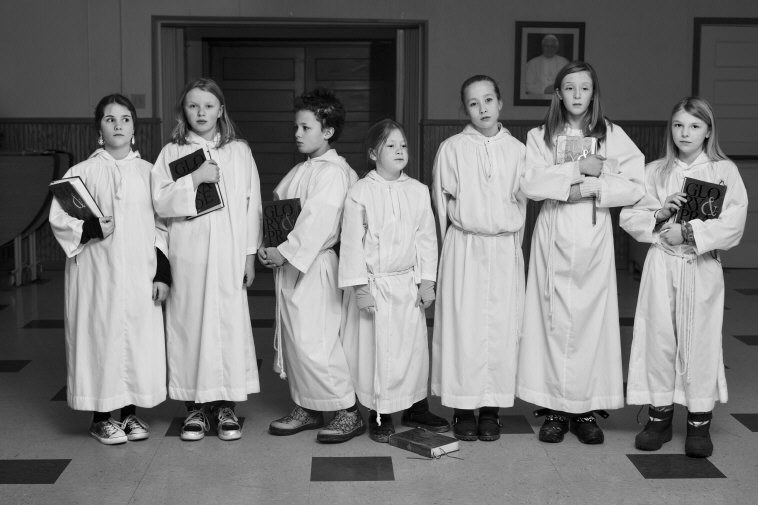 A group of children in white robes at Sunday choir