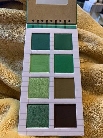 palette that looks like a notepad and holds eight green eyeshadows in different shades