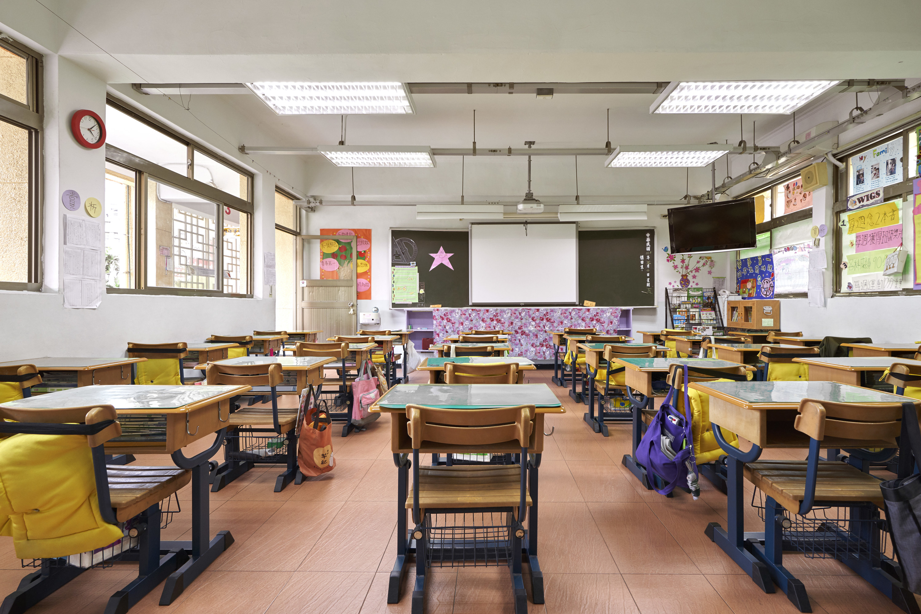 elementary school classroom with backpacks at desks