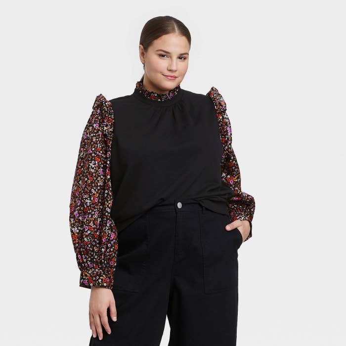 model in the top with black bodice and floral collar and sleeves