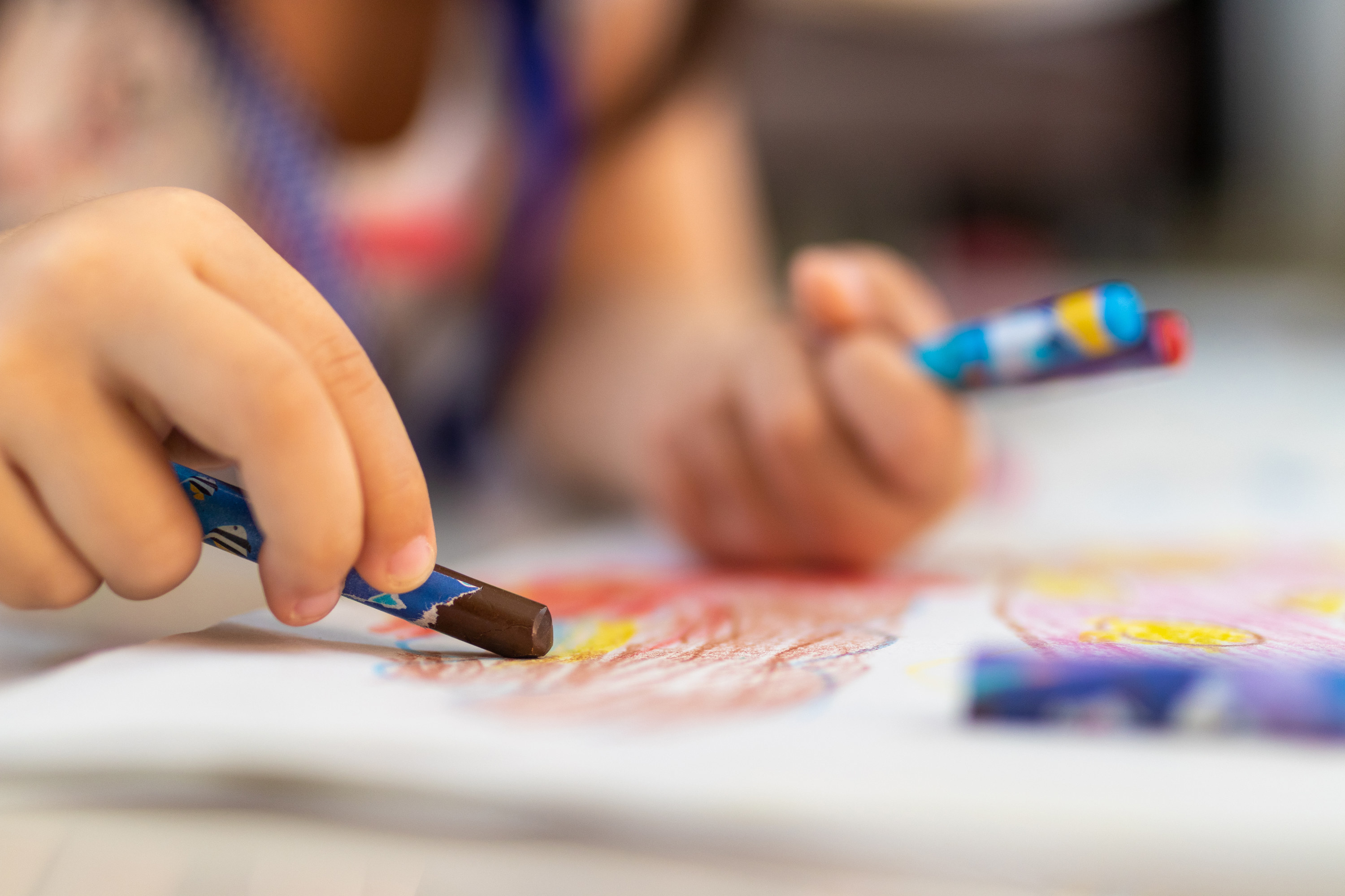 A child drawing with crayons