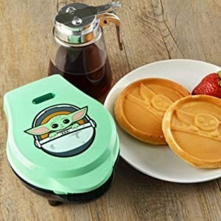 lifestyle image of green mini waffle maker, baby yoda waffles