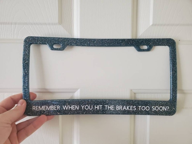 a blue glittery license plate frame that says &quot;remember when you hit the brakes too soon?&quot;