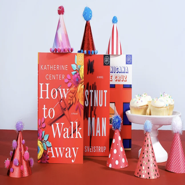 three books with birthday hats on them