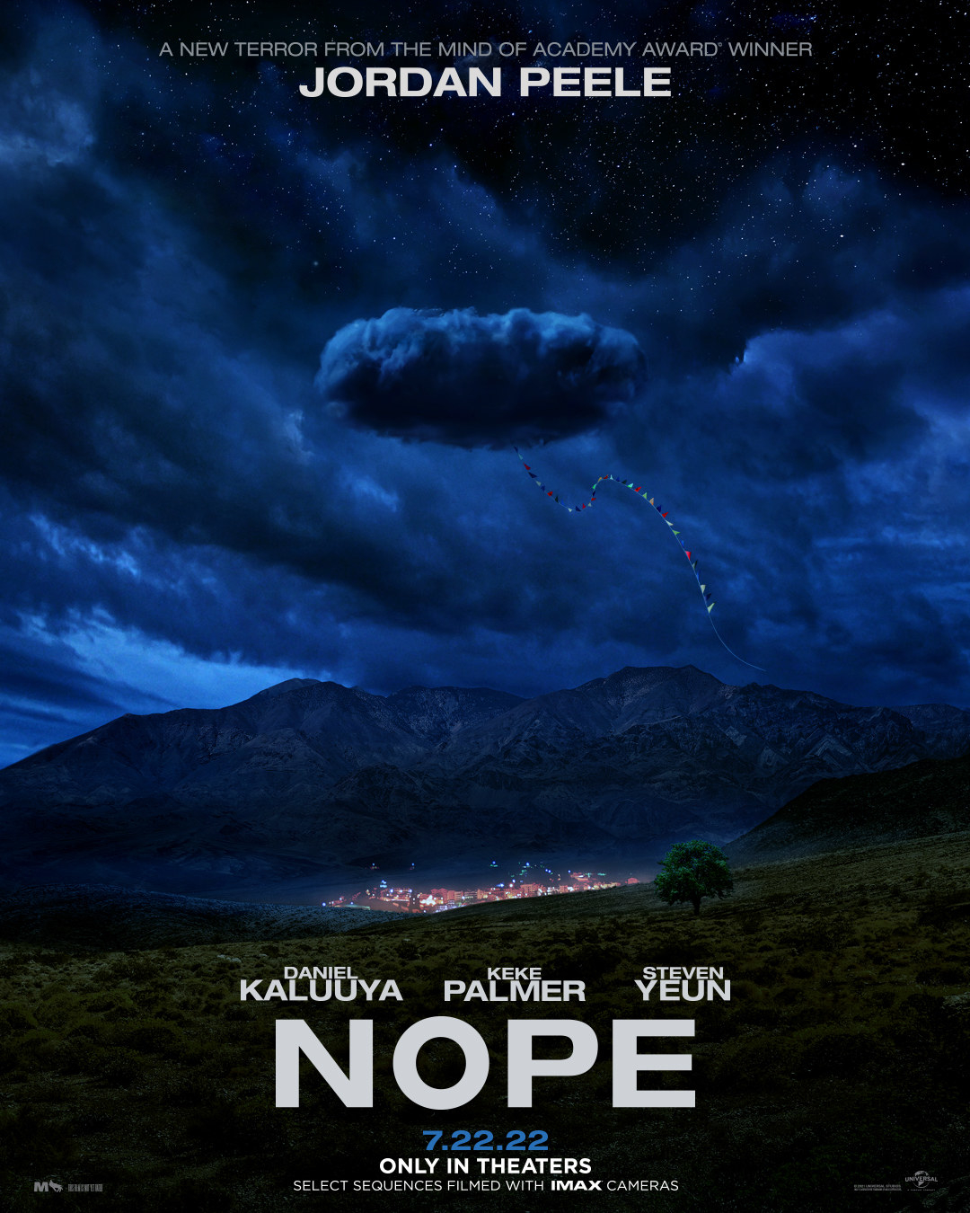 Poster for the movie Nope by Jordan Peele, featuring a cloud with a kite tail coming out of it hovering over a small lit up town