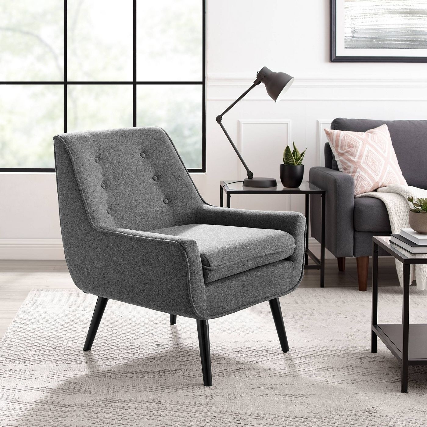 A tufted gray chair in a living room
