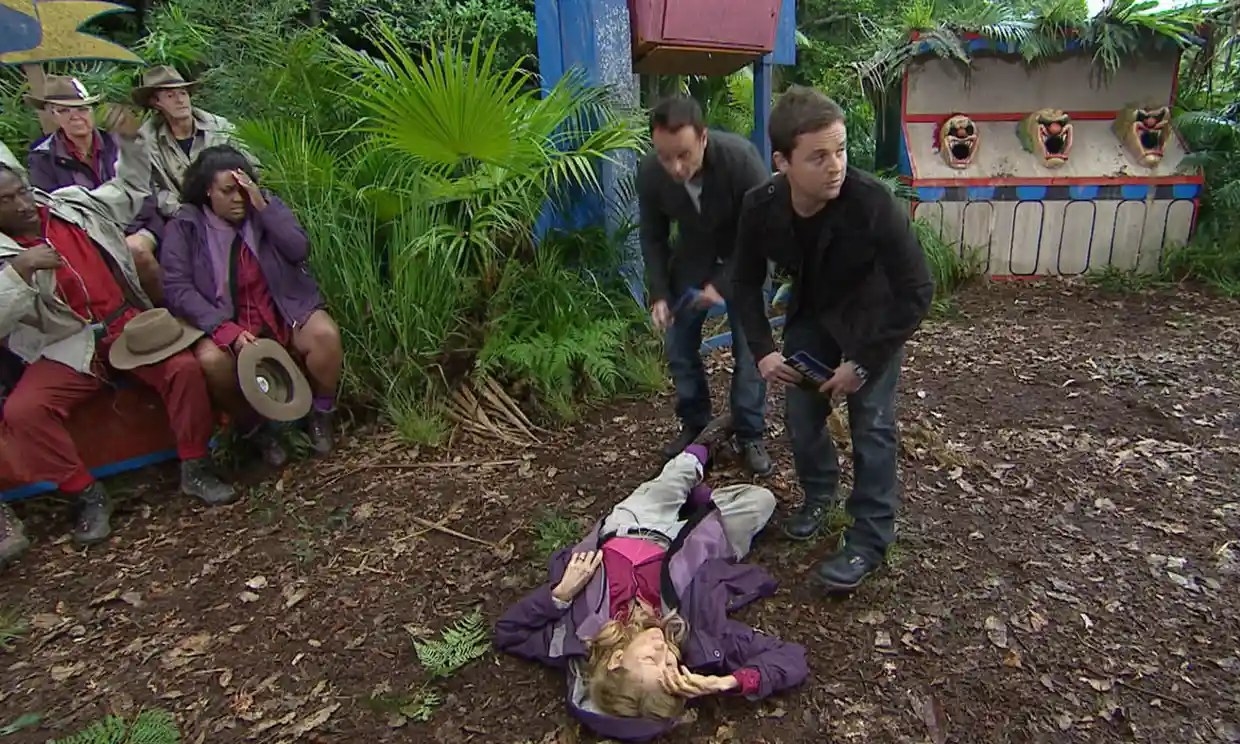 gilian mckeith lying on the ground in the jungle while the contestants and ant and dec look concerned