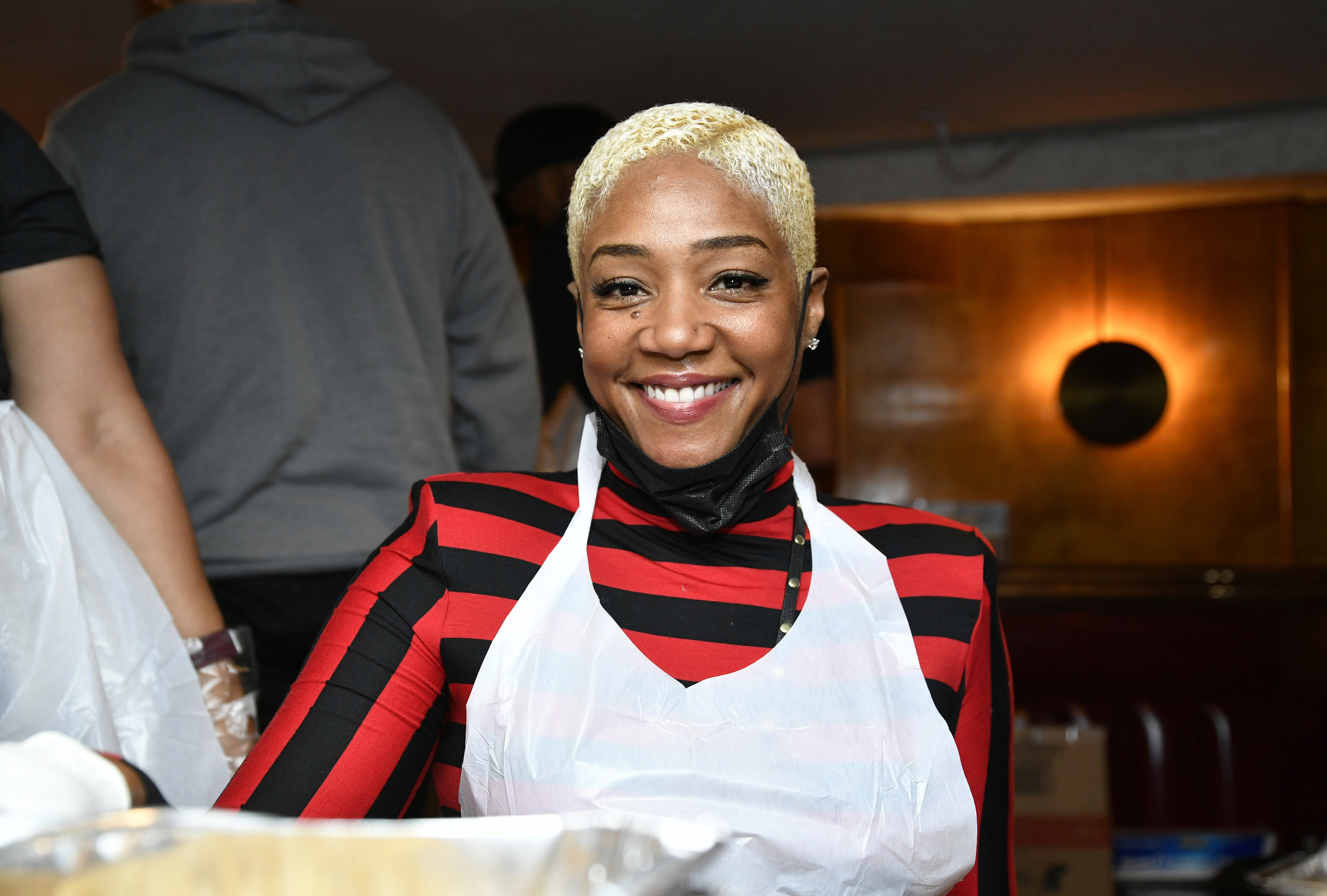 Haddish smiles for the camera while wearing an apron