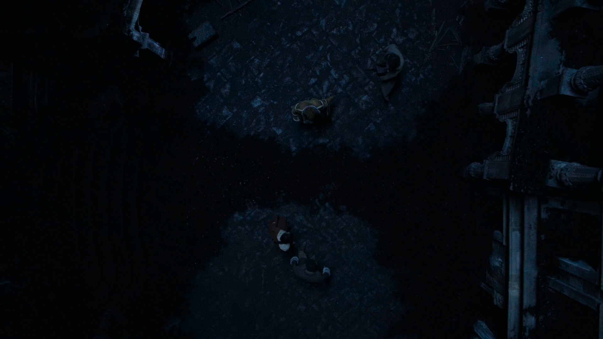 Overhead shot of a cobbled street in Shadar Logoth, with Mashadar, a creeping, black, ink-like substance cutting off our heroes from one another – Mat and Rand on one side, Perrin and Egwene on the other