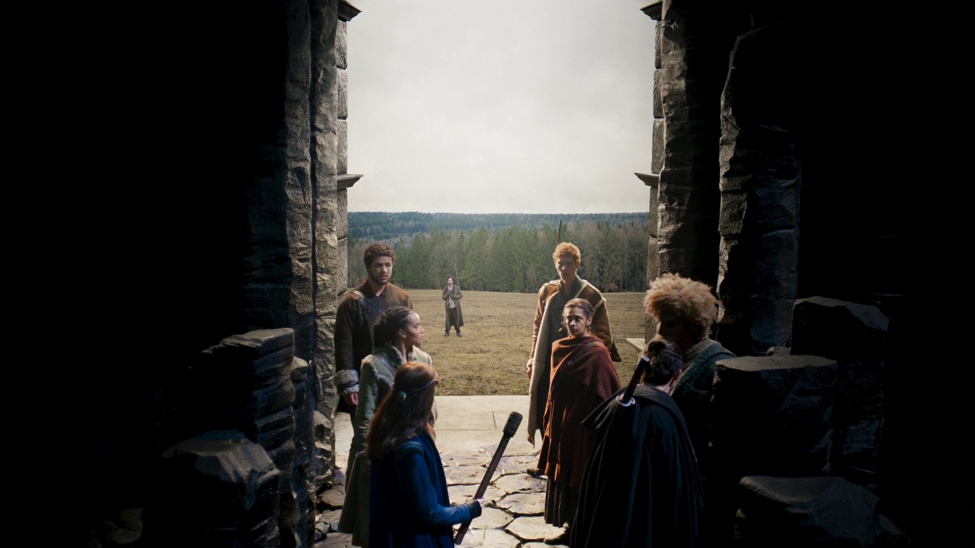 A shot from inside the Waygate, showing all of the main characters have entered, except for Mat, who stands alone on the hilltop outside the Waygate