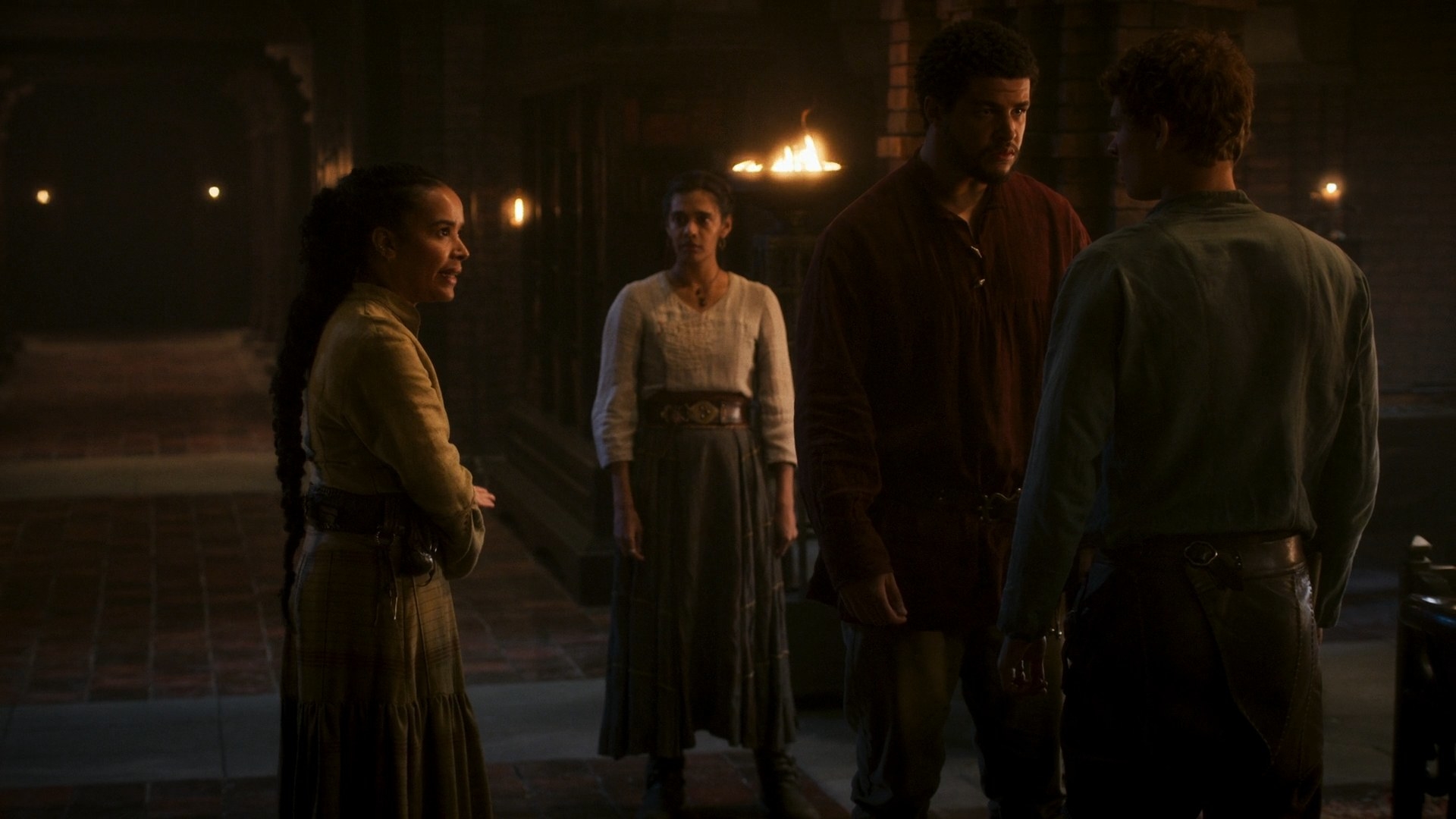 A wide shot in Fal Dara Keep showing Perrin and Rand facing each other down, with Nynaeve gesturing angrily towards Egwene. Egwene, in the background, looks on, confused