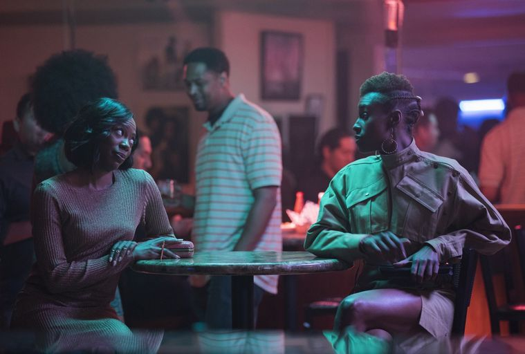 Insecure&#x27;s molly and issa sitting in a dimly lit bar