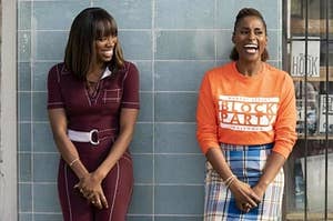 insecure's molly and issa standing by a wall and laughing