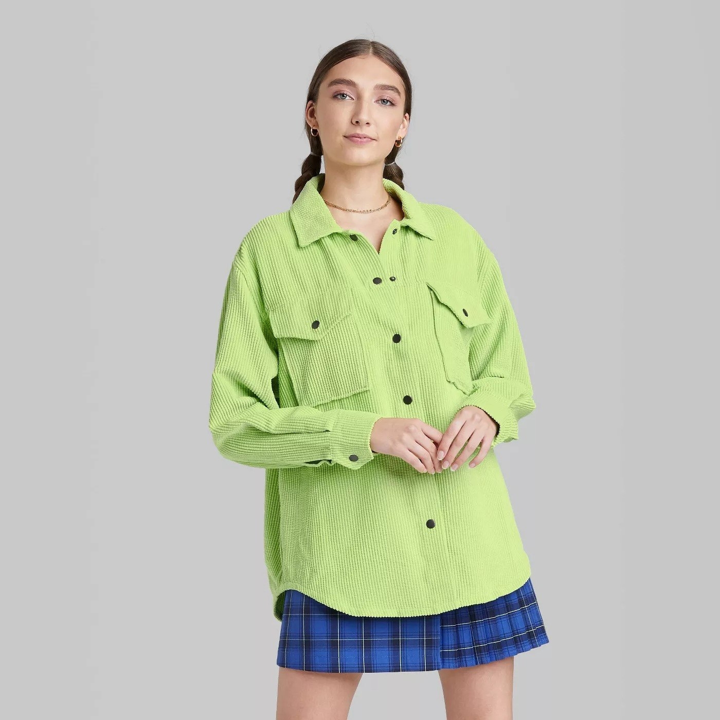 Model wearing neon cord jacket with black buttons