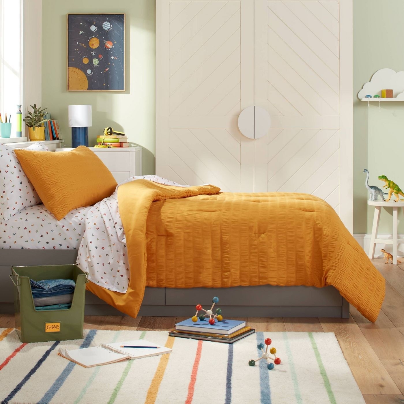 A bed with a mustard yellow duvet