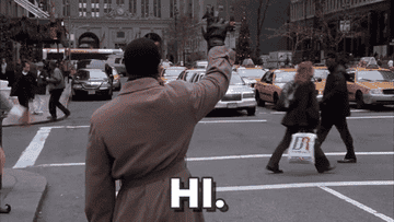 A man stands in the street and waves for a taxi before Will Ferrell as Buddy stephs into the street and waves and him and says