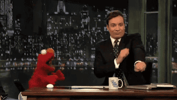Elmo and Jimmy Fallon doing a happy dance
