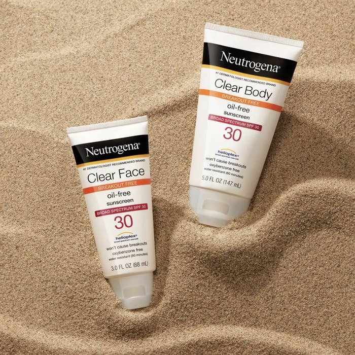 Two bottles of Neutrogena oil-free sunscreen in the sand