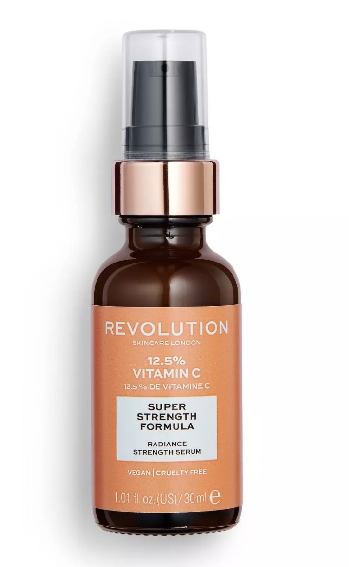 Bottle of Revolution Vitamin C serum with orange label