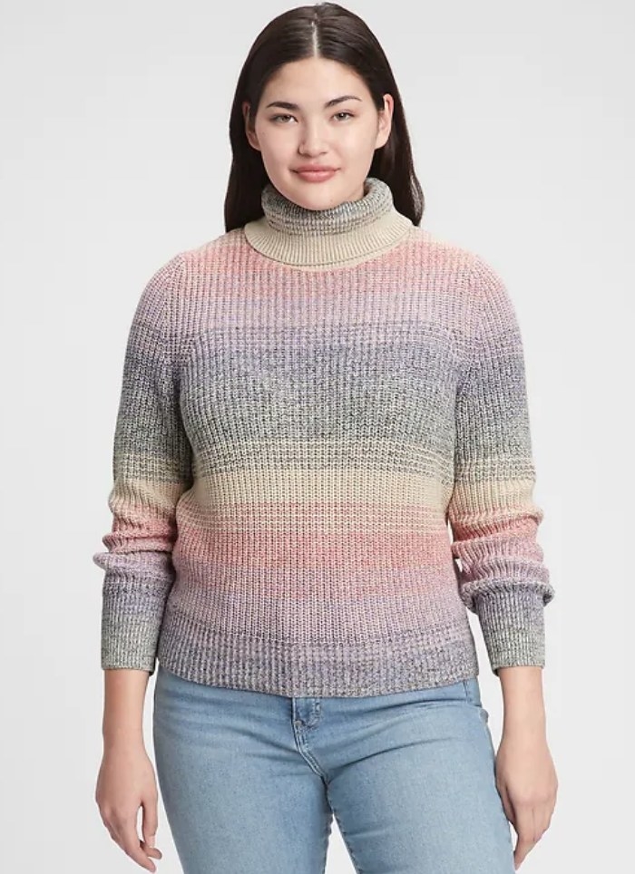 A model wearing a multi-colored turtleneck sweater
