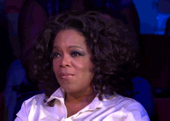 ID: Oprah Winfrey cries and puts a hand to her heart