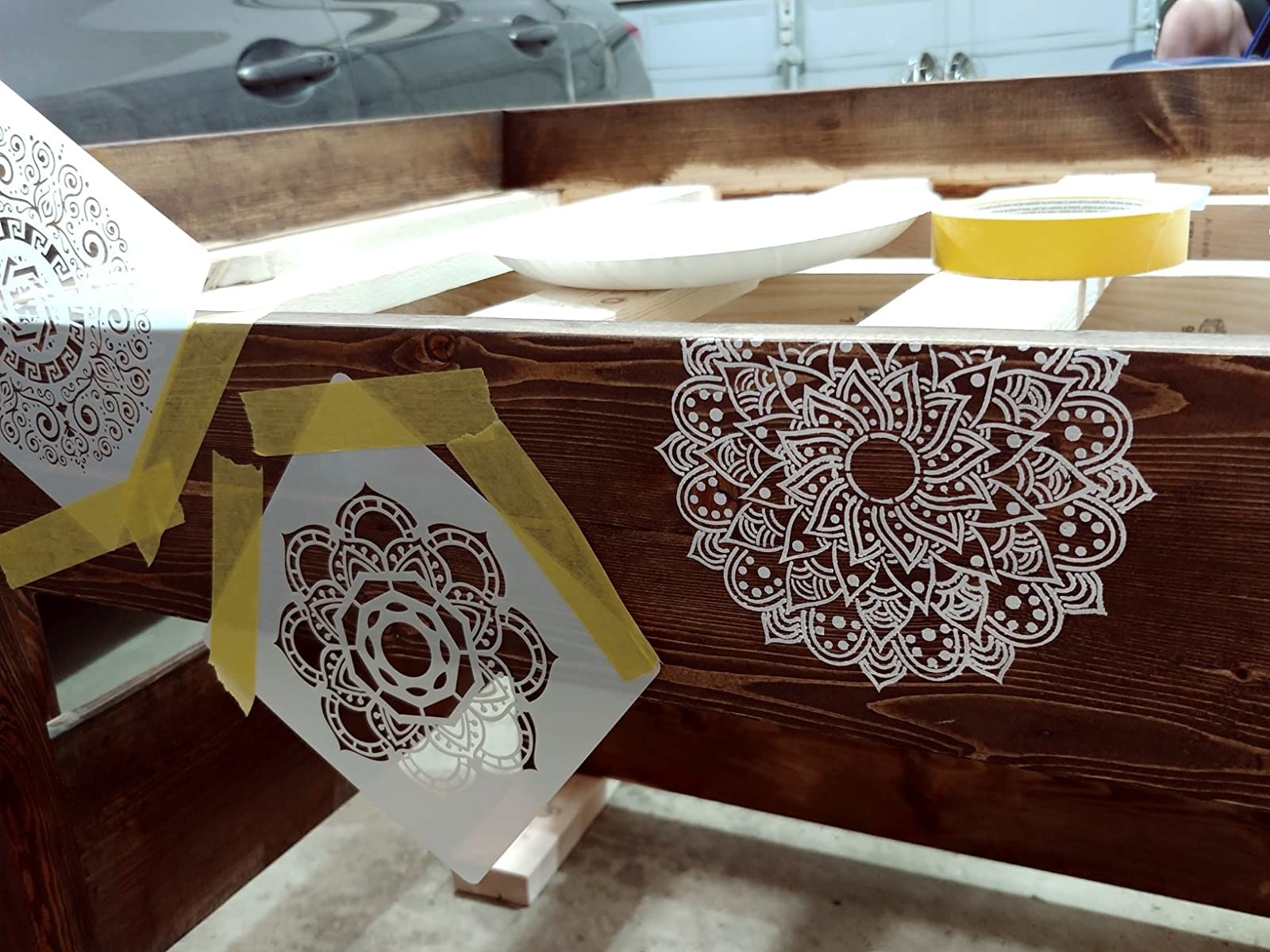 reviewer image of stencils taped onto a wooden table