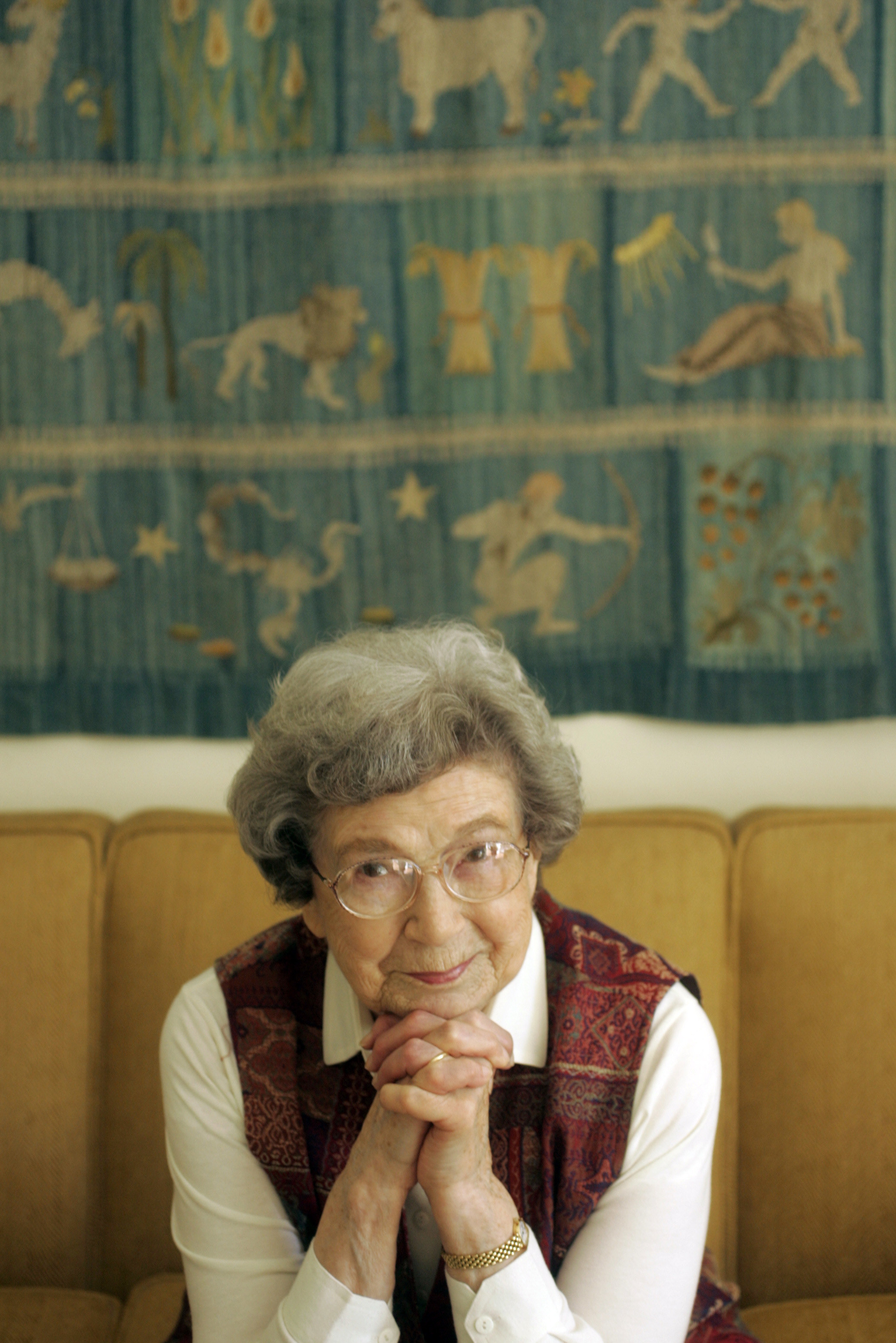 Beverly Cleary on a couch resting her head on her hands