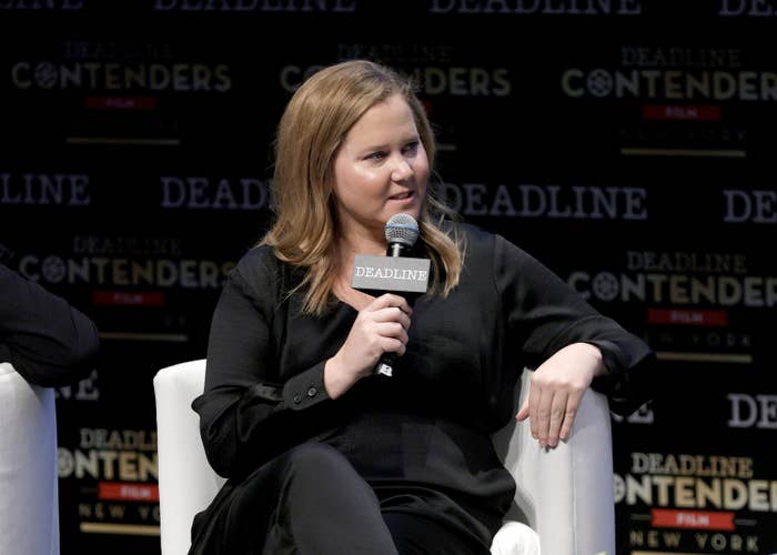 Amy sitting onstage during a panel discussion with Deadline