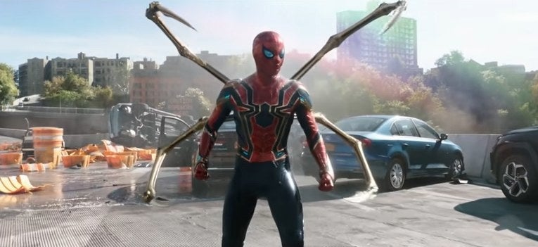 Spider-Man standing on a ruined highway in his Iron Spider suit with his four robot arms out in &quot;Spider-Man: No Way Home&quot;