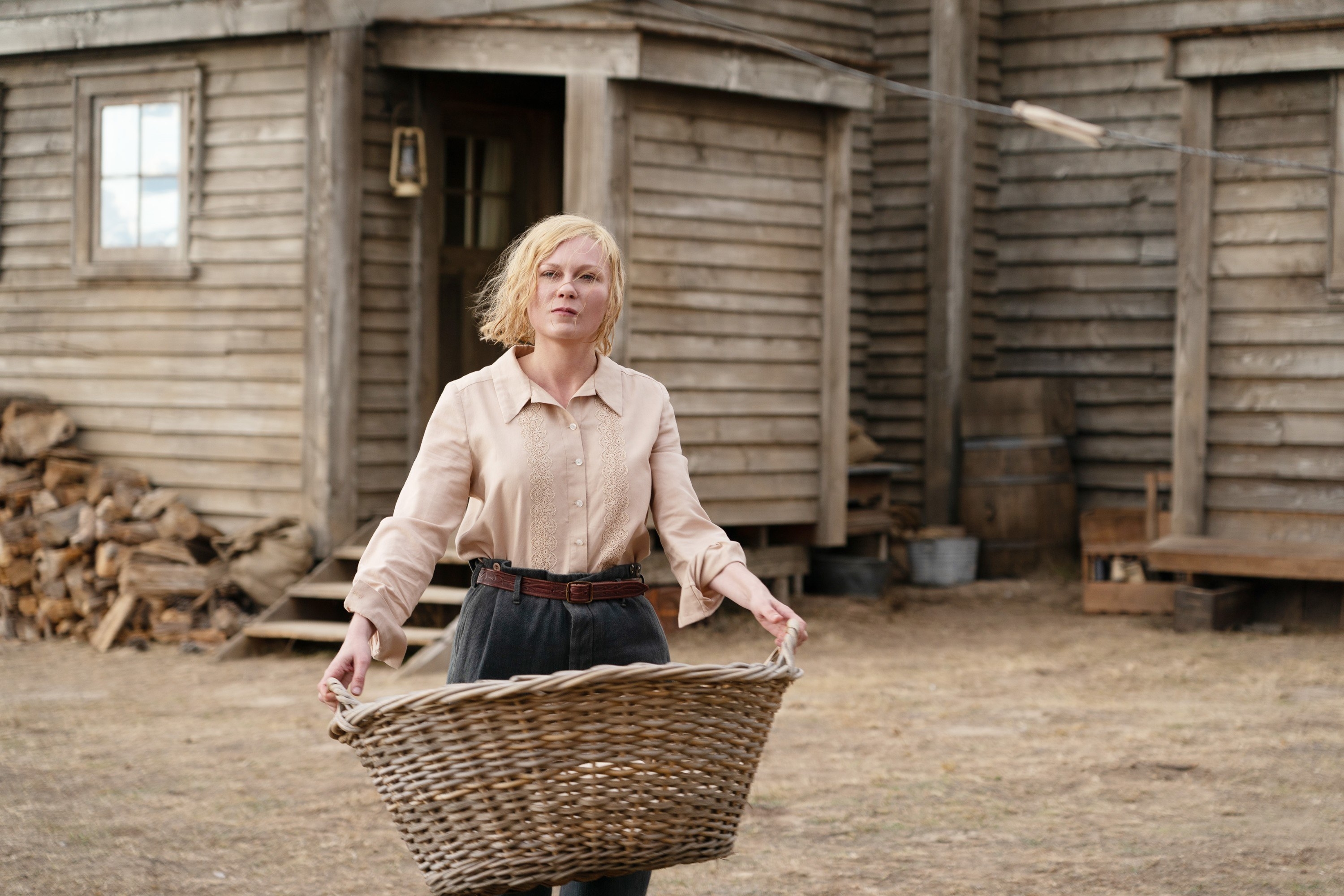 Kirsten Dunst carries a laundry basket