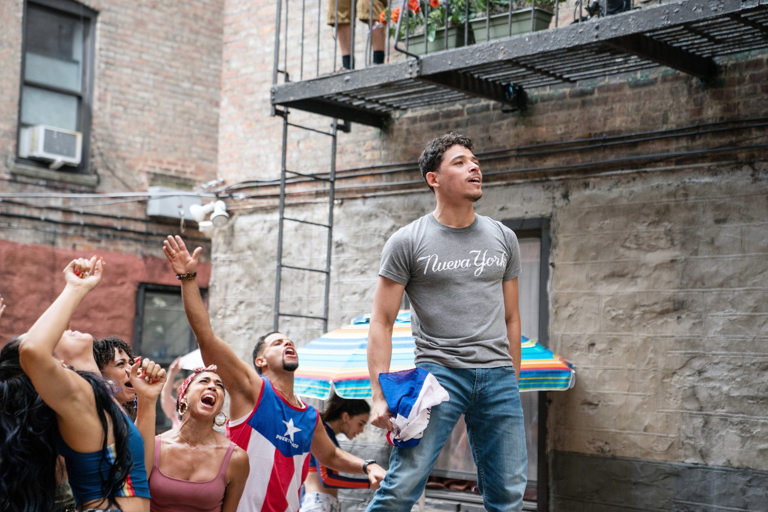 Anthony Ramos stands on a podium singing