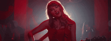 a gif of taylor swift playing guitar and singing in the &quot;I bet you think about me&quot; music video